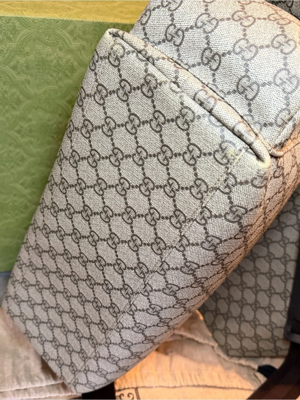 GG Supreme canvas diaper bag, designed with multiple pockets and fold-out pad